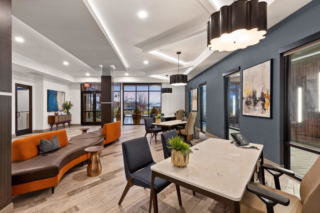 Conference area with tables and chairs, modern lounge furniture, and decorative lighting