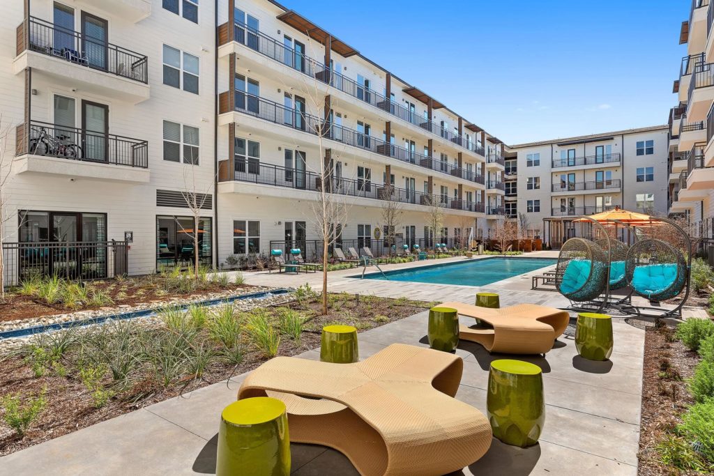 Pool area with modern lounge furniture and tables